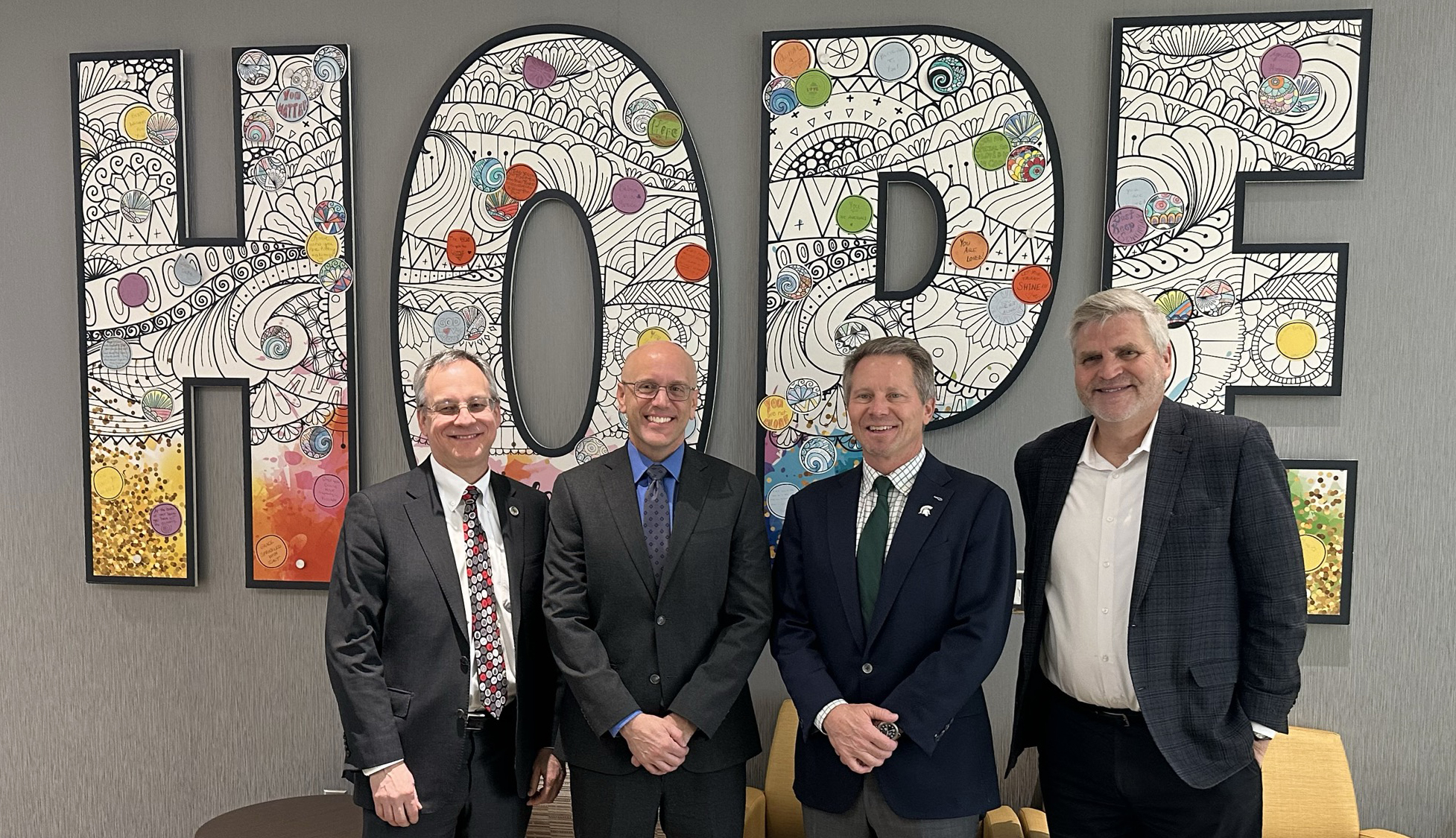 (L-R) Aron Sousa, William Sanders, DO, chief medical officer of Pine Rest Christian Mental Health Services, Kevin Guskiewicz, PhD, president of Michigan State University, and Mark Eastburg, PhD, president and CEO of Pine Rest Christian Mental Health Services.